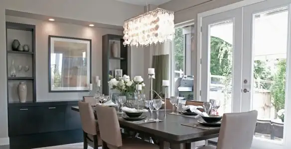 Elegant dining room chandelier installation above table in Overland Park, KS
