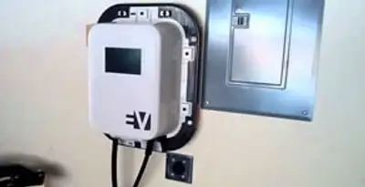 Electric car charger installation with wall-mounted EV charging station in Overland Park, KS