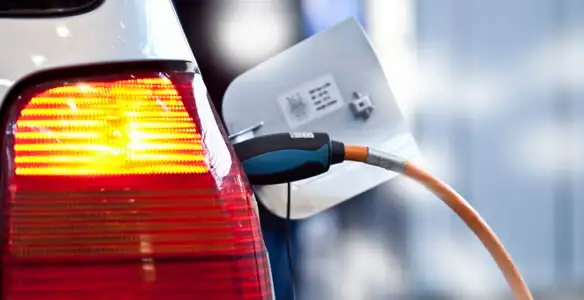 Electric car plugged into EV charger after professional installation in Overland Park, KS