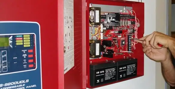 fire alarm installation service showing technician configuring fire alarm control panel in Overland Park, KS
