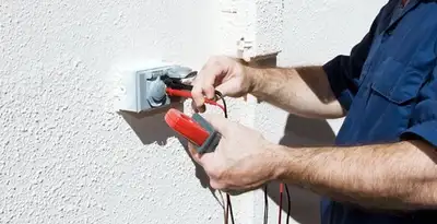 Electrician performing home electrical outlet and wiring inspection in Overland Park, KS
