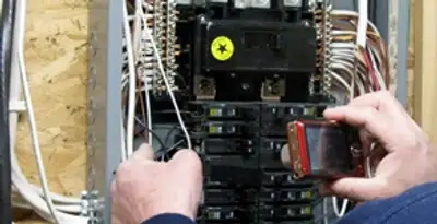Home electrical inspection of circuit breaker panel by licensed electrician in Overland Park, KS