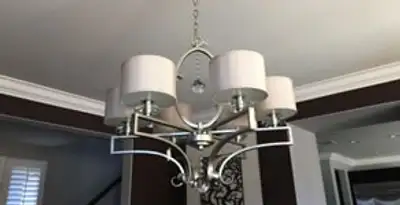 Modern chandelier installation with multiple light fixtures in Overland Park, KS