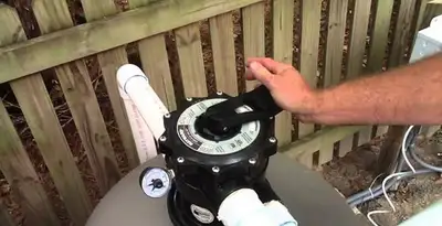 pool pumps service showing professional adjustment of pool pump control system in Overland Park, KS