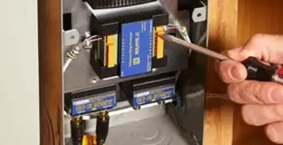 Whole home surge protection device being installed by a licensed electrician to protect electrical systems in Overland Park, KS